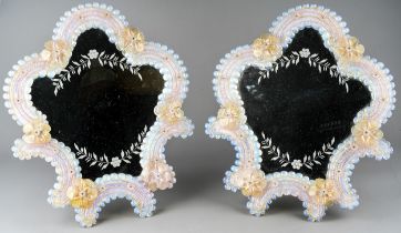 A pair of early 20th Century Murano easel back mirrors, cartouche shaped applied with flowers,