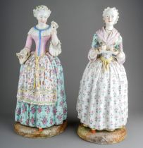 Two 19th century very large Meissen figures, depicting ladies in floral dresses, with crossed swords