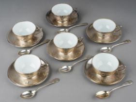 A set of six Continental white metal mounted ceramic coffee cups with matching white metal saucers