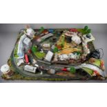 A model railway N gauge train layout fixed on board, the diorama features wintery village scene with