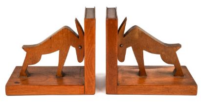 A pair of mid century carved wood book ends in a form of an abstract animals. The ends and sides