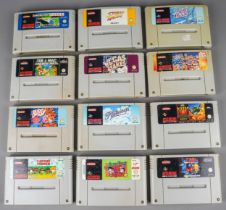 An assortment of twelve loose Super Nintendo (SNES) cartridges, games to include: Super Tennis,
