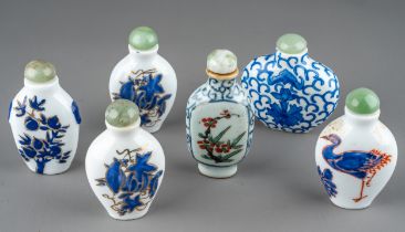 A collection of Chinese porcelain snuff bottles, including a pair of ovoid bottles enameled with