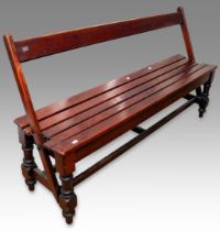 An early 20th Century slatted wood tram bench with reversible back rest, on turned supports, 152cm