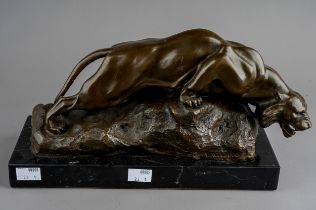Giacomo Merculiano (1859-1935), a bronze of a crouching snow tiger on rocks signed Merculiano and