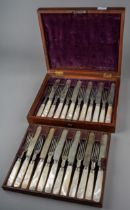 A late 19th Century set of twelve fruit knives and forks with mother of pearl handles, plated blades