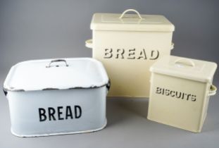 Kitchenalia: a collection of three vintage style bread and biscuit tins and a large yellow cast