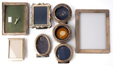 A collection of silver photograph frames, including round, oval and rectangular Many are worn and