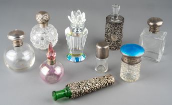 A collection of nine glass scent bottles including two cut glass globular bottles with screw-on