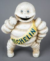 A cast metal Vintage style figure of the Michelin Man, the yellow sash with Reg 67548 Detroit to