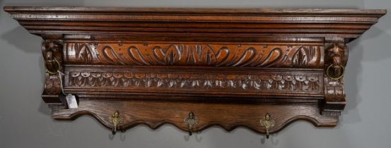 An Edwardian carved oak overmantel style wall hanging applied with brass coat hooks, approx 93cm