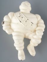 A vintage cast Michelin man, seated wearing Michelin sash, approx 11.5cm long