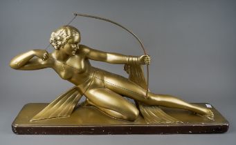 After Salvatore Melani, an Art Deco style large gilt plaster model depicting a Goddess with bow on