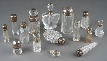 A collection of assorted silver mounted cut glass scent bottles and jars, of various shapes and