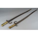 Two 19th Century French pattern Chassepot sword bayonets with steel scabbards, brass grips,