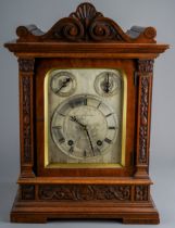 An early 20th Century mahogany cased mantle 8 day clock, the silvered dial with Roman numerals,