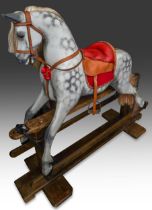 An early 20th Century dapple grey rocking horse in the style of a Lines Brothers "Sportiboy mark 2",