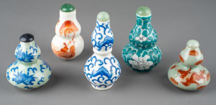 A collection of Chinese porcelain double gourd snuff bottles, including celadon ground, blue and