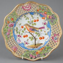 A 19th century Meissen reticulated plate, hand painted with a bird sat upon a cherry tree,