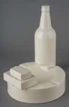 Robin Levien - novelty cream ware pottery in the form of an ash tray, a bottle of beer, a