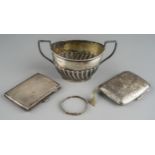 A group of early 20th Century silver to include two cigarette cases, a child's bangle and a Georgian