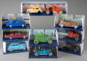 A collection of Tintin Herge Moulinsart die cast models, all in perspex case with background