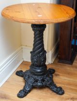 A Victorian style large circular occasional table with cast iron base and modern wooden top (1)