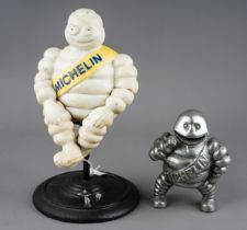 A cast metal model of a revolving Michelin man, with yellow sash, approx 30cm high and a chrome