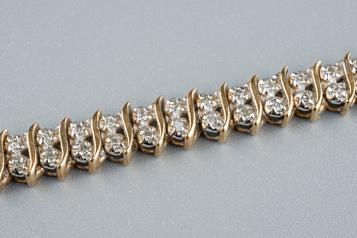 A 9ct gold and diamond line bracelet, with two round brilliant-cut diamond set links between S - Image 4 of 5