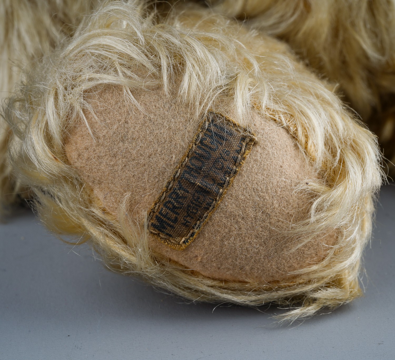 A 1930's Merrythought teddy bear, with blonde mohair, one orange and black glass eyes, black - Image 4 of 5