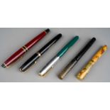 A collection of four vintage Waterman's fountain pens to include: an Ideal marbled fountain pen, the