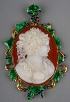 An 18ct yellow gold cameo pendant, the oval cameo carved depicting a lady, within an enamelled