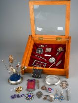 A collection of silver, including medals, enamelled badges, propelling pencil, cheroot holder,