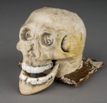 A 19th Century parian inkwell modelled as a skull with recess to top of skull, glazed teeth and