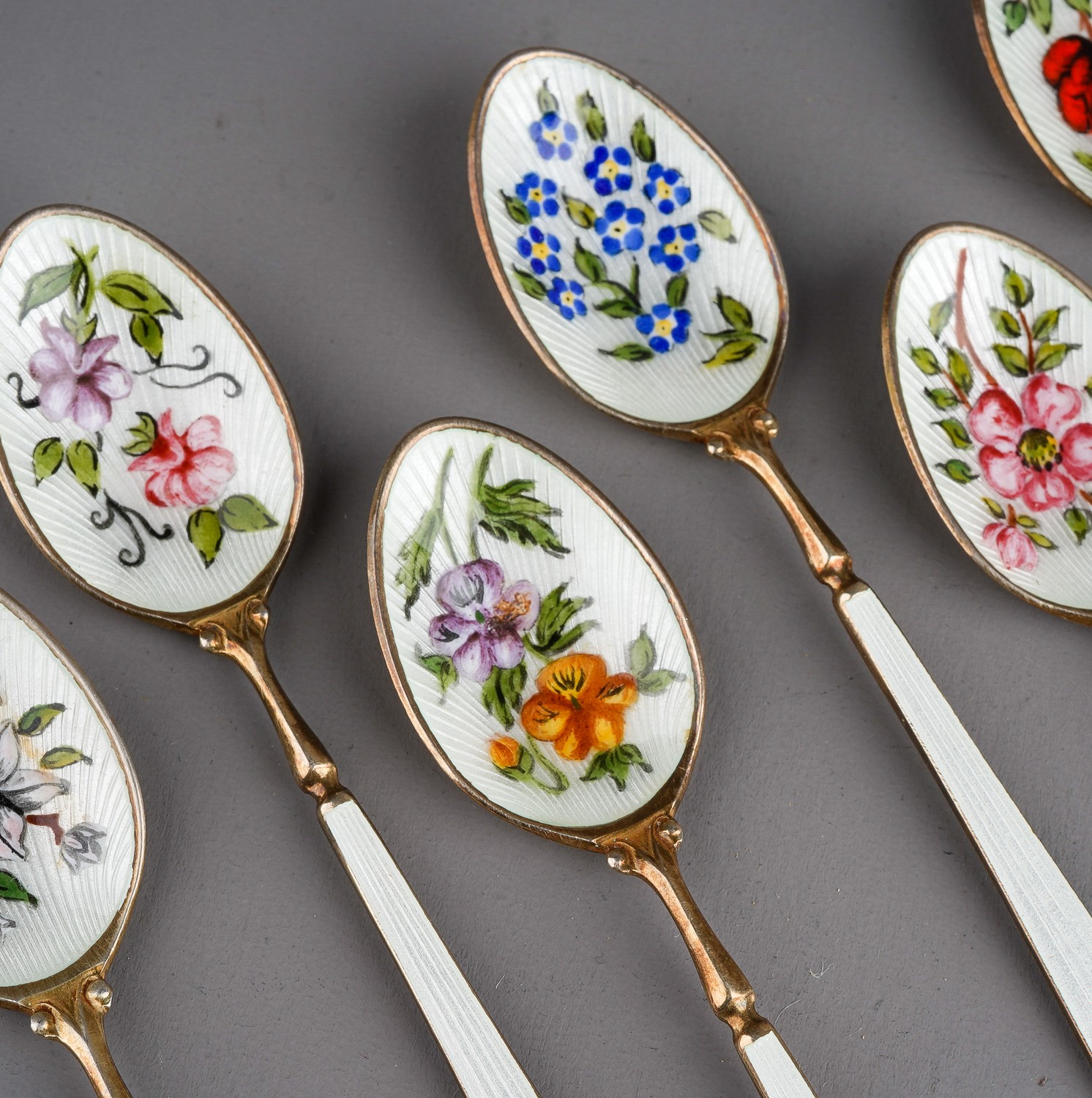 A set of six Modern silver gilt and enamel teaspoons, the bowls decorated with flowers, roses, - Image 3 of 4