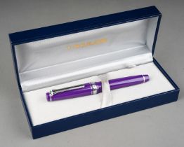 A group of three Japanese Sailor fountain pens in yellow, purple or red, all with 14k white or