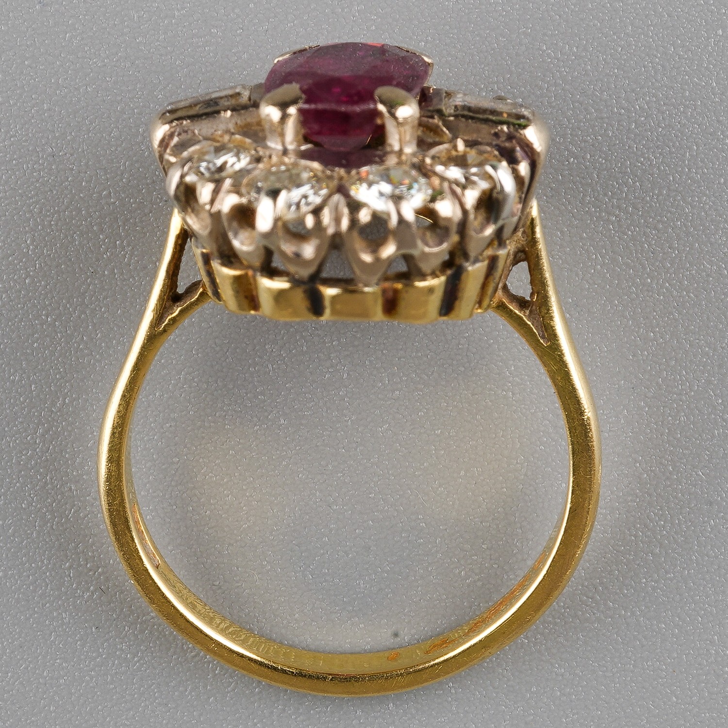 An 18ct yellow gold ruby and diamond cluster ring, set with an oval-cut ruby within a border of - Image 3 of 5