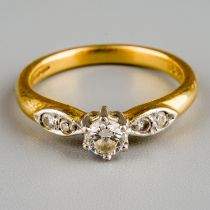 An 18ct yellow gold and diamond solitaire ring, the central round brilliant cut diamond approx 0.