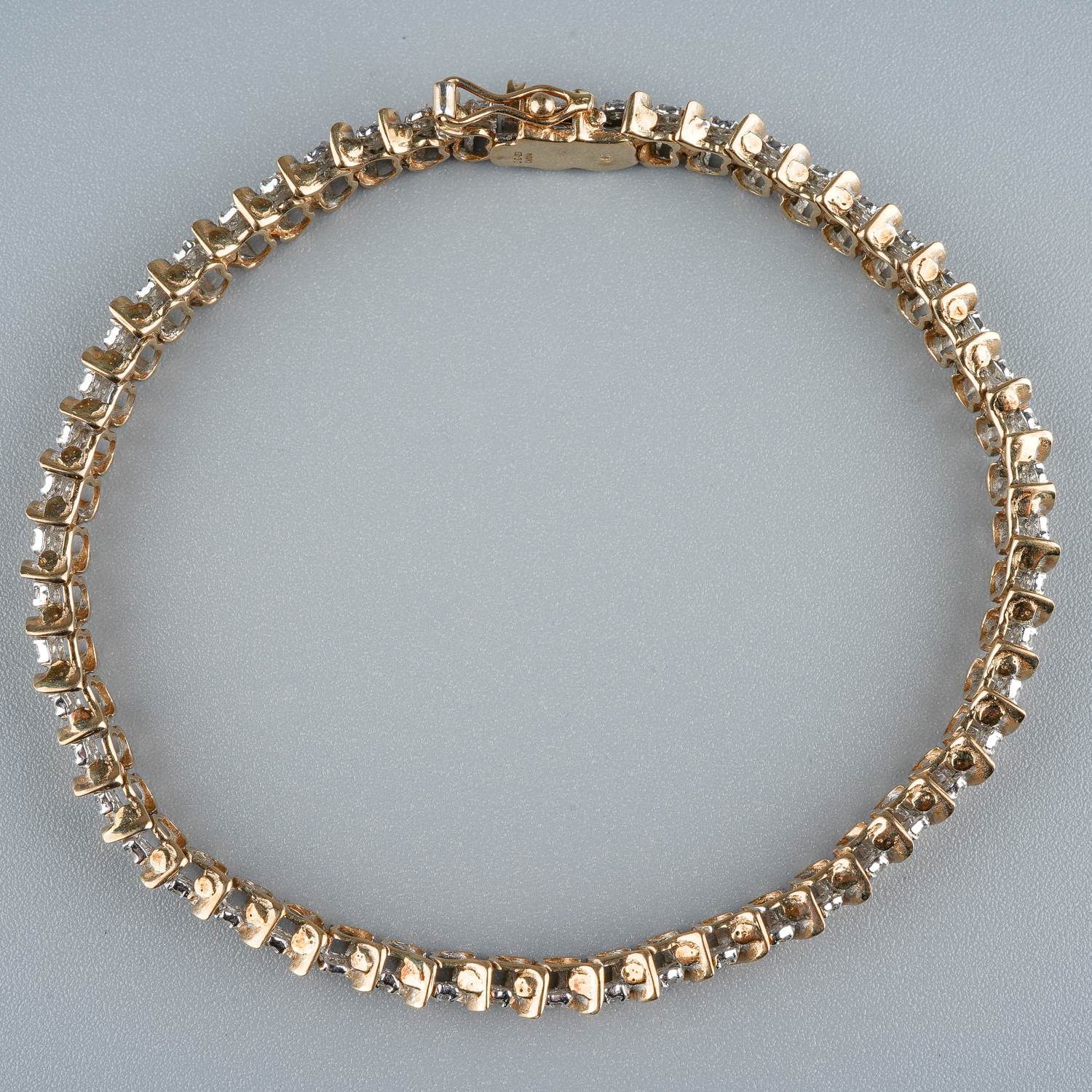 A 9ct gold and diamond line bracelet, with two round brilliant-cut diamond set links between S - Image 2 of 5