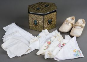 A vintage hexagonal Don Confectionery Co Ltd biscuit tin with a pair of Child's cream shoes and