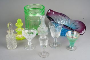 A collection of Georgian style cut drinking glasses together with cut and moulded condiment bottles,