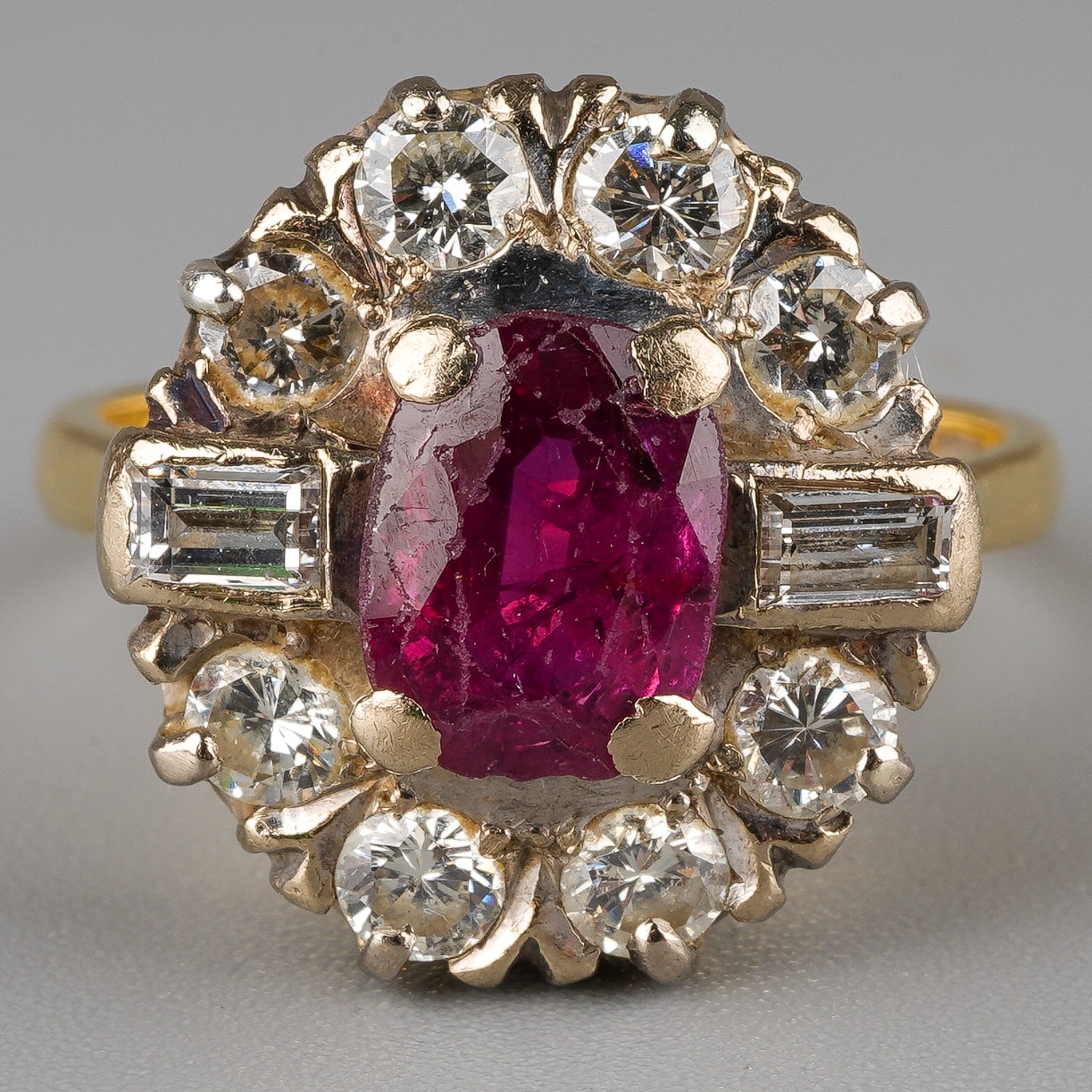 An 18ct yellow gold ruby and diamond cluster ring, set with an oval-cut ruby within a border of - Image 2 of 5