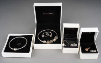 A collection of silver jewellery, including two Pandora bracelets, rings, silver and CZ rings,