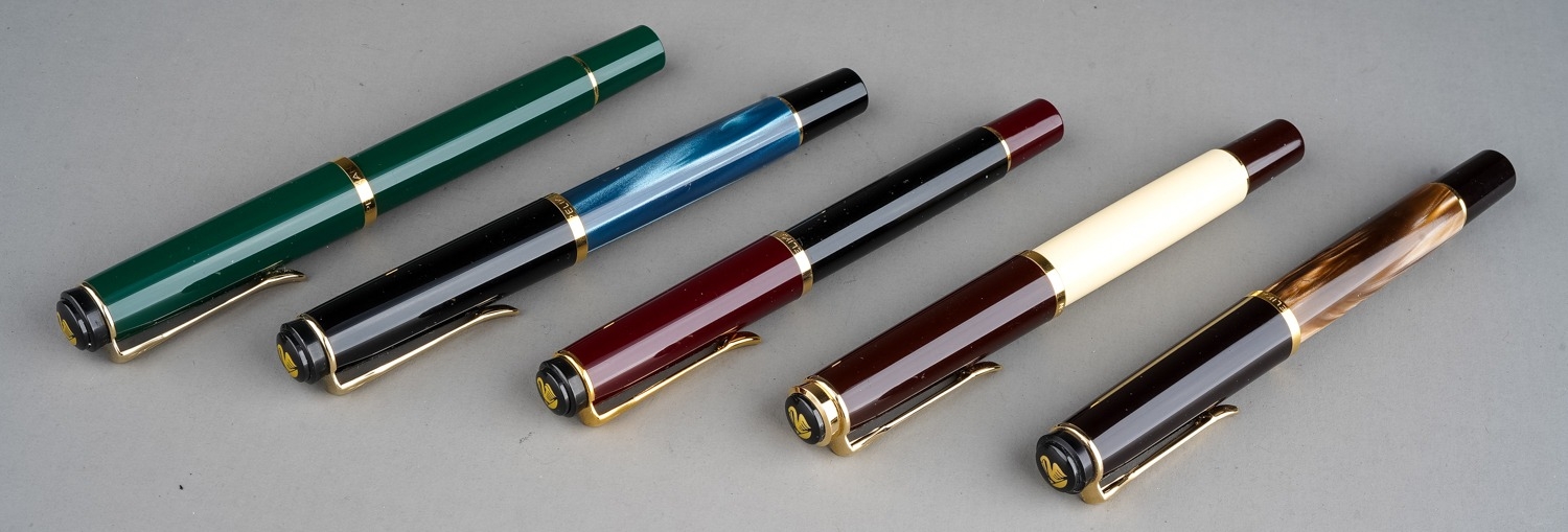 Five Pelikan fountain pens, each cover band stamped PELIKAN, colour combinations include: burgundy &
