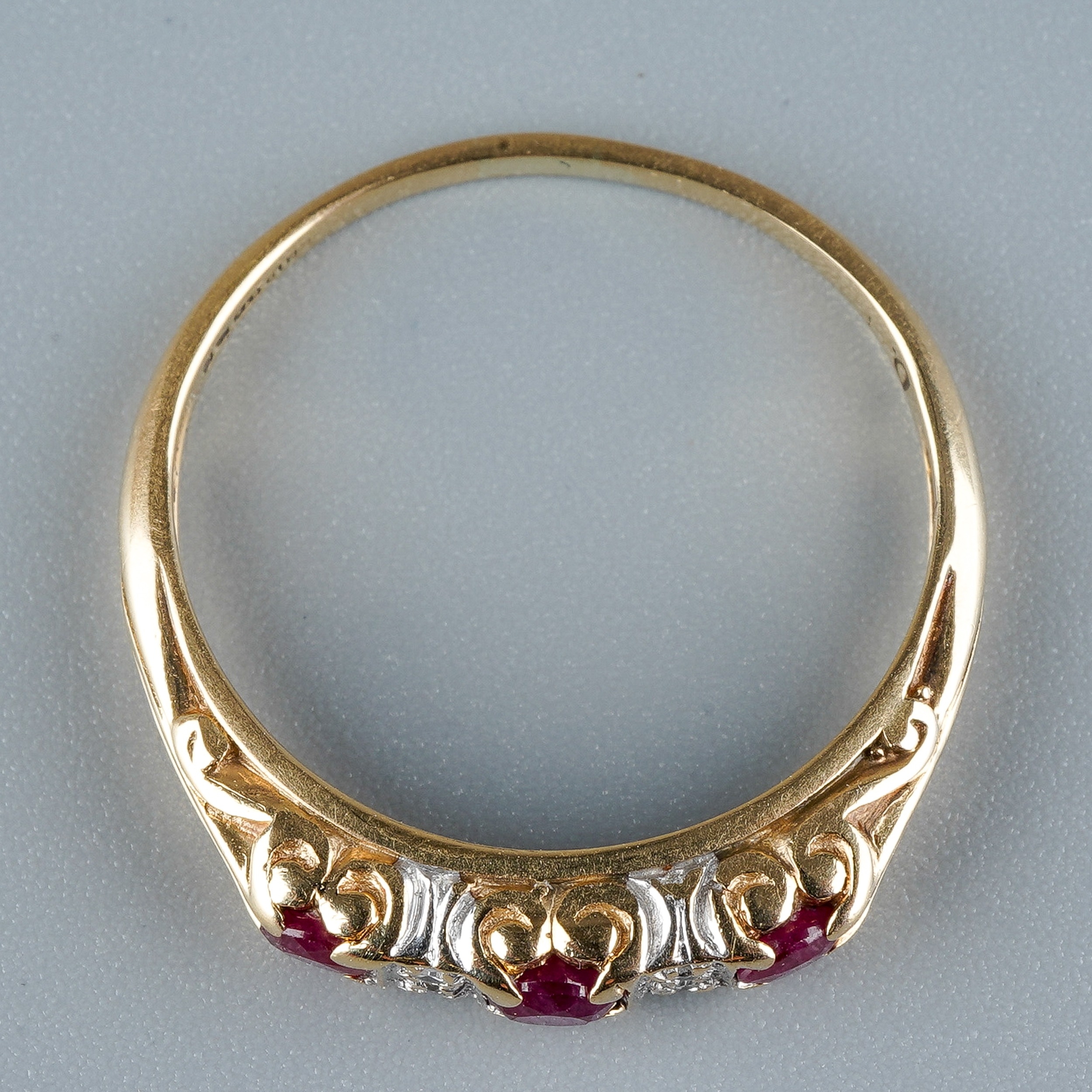 A 9ct yellow gold ruby and diamond ring, set with three round-cut rubies with diamond-chip - Image 3 of 6