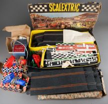 A vintage Tri-Ang Scalextric Model Electric Motor Racing with boxed hand throttles, tracks and