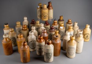 Thirsty-Six stoneware ginger beer bottles, mostly Birmingham, Manchester, all with black transfer
