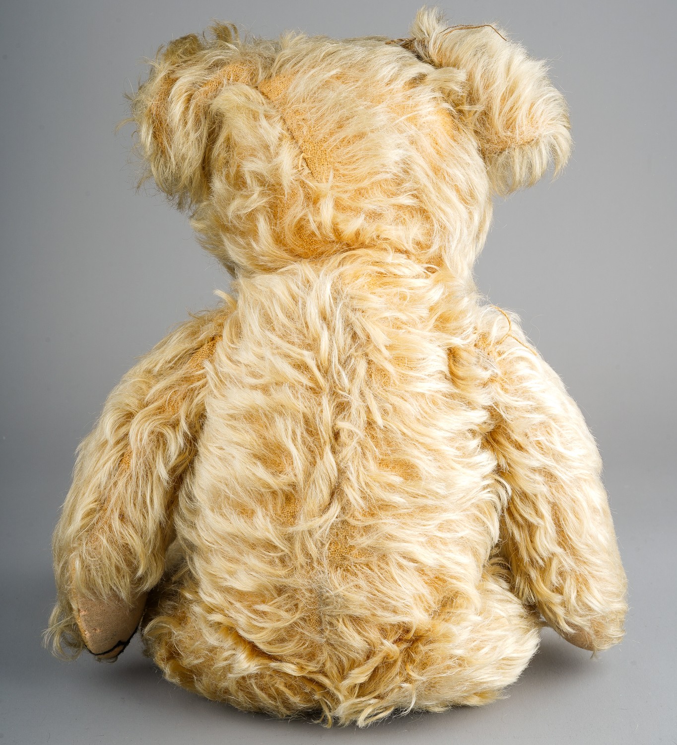 A 1930's Merrythought teddy bear, with blonde mohair, one orange and black glass eyes, black - Image 2 of 5