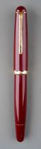 A Montblanc Monte Rosa red fountain pen with gilt fittings, the 14c gold nib stamped MONTE ROSA