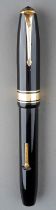 A vintage Conway Stewart 100 black and gilt fountain pen with 14ct gold nib, stamped Duro Conway